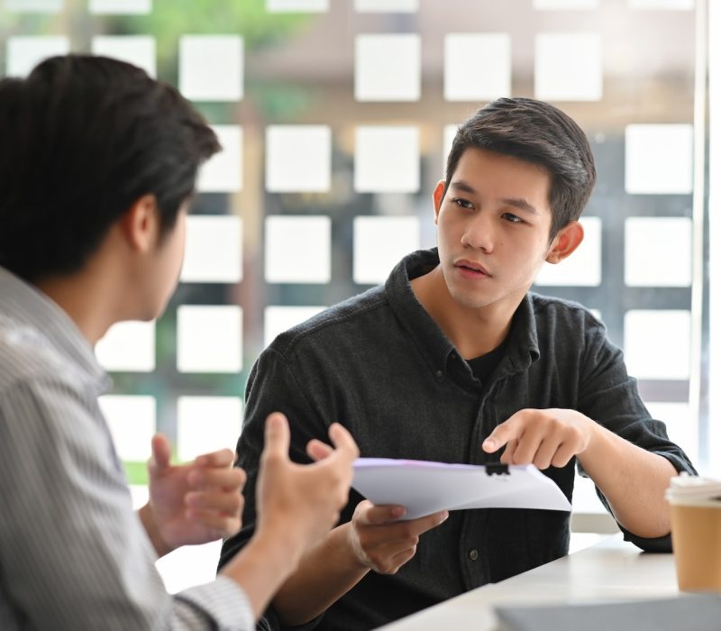 asian-young-man-consulting-with-paper-document-on-modern-office-.jpg