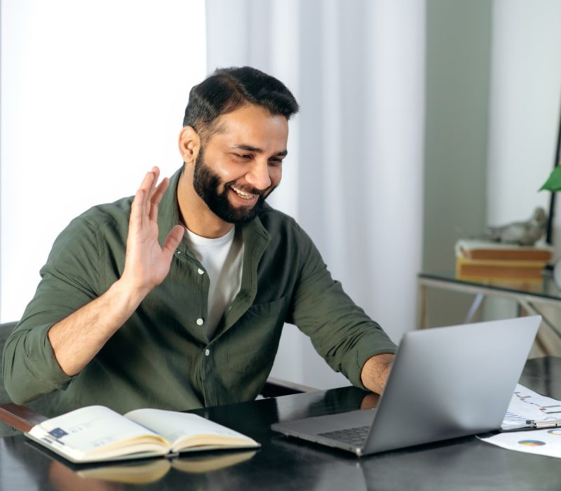 pleasant-friendly-indian-guy-manager-or-financial-consultant-communicates-with-colleagues-on-a.jpg